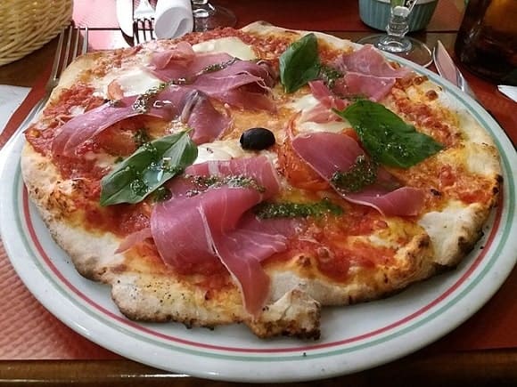 a pizza on a plate at a restaurant
