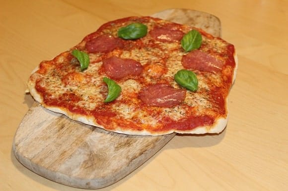 a yummy homemade pizza on a wooden plank