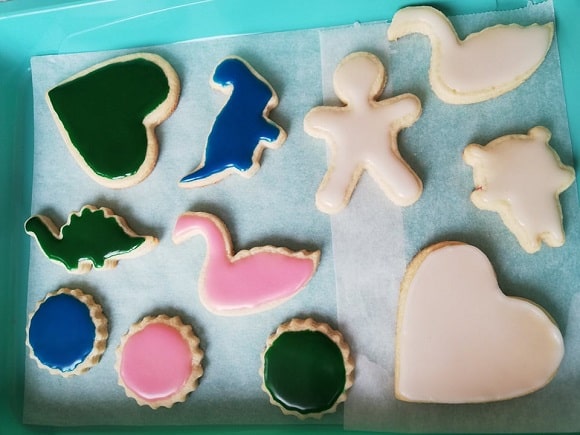 an image of vanilla cookies in different shapes topped with colorful icing
