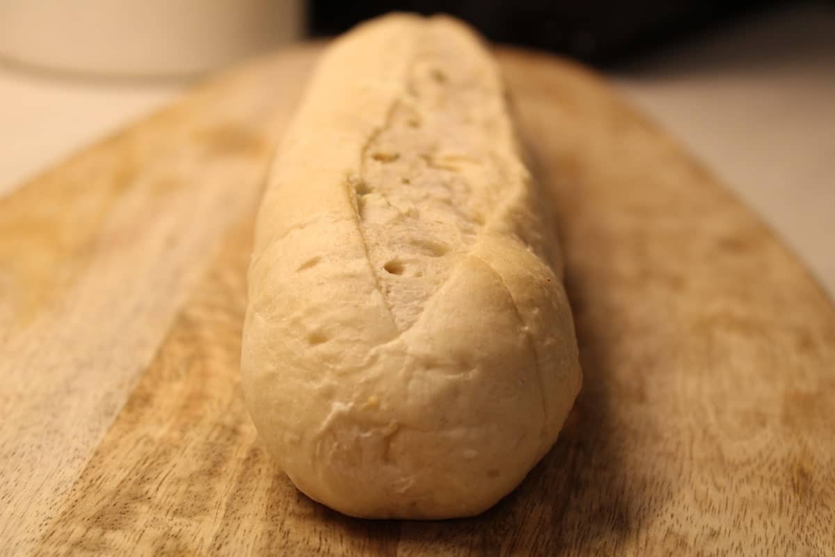 a thawing garlic bread on a wooden plank