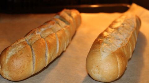 two frozen garlic breads baking in the oven