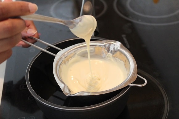 white chocolate being melted over boiling water
