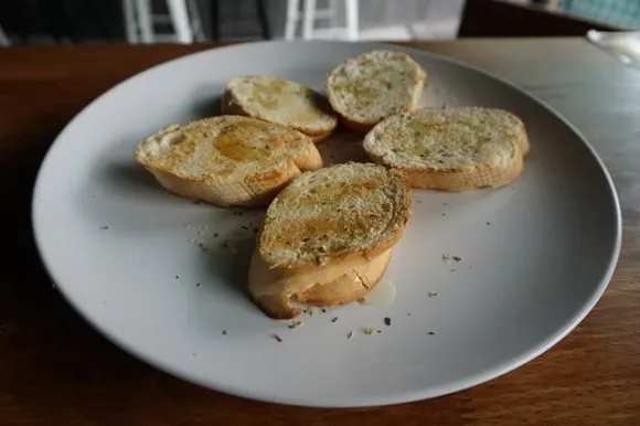 a couple of frozen garlic bread slices on a dinner plate