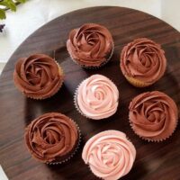 a plate with beautiful rose chocolate cupcakes