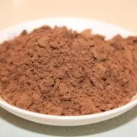 Natural cocoa powder on a small plate