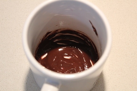 a mug with cocoa paste in it