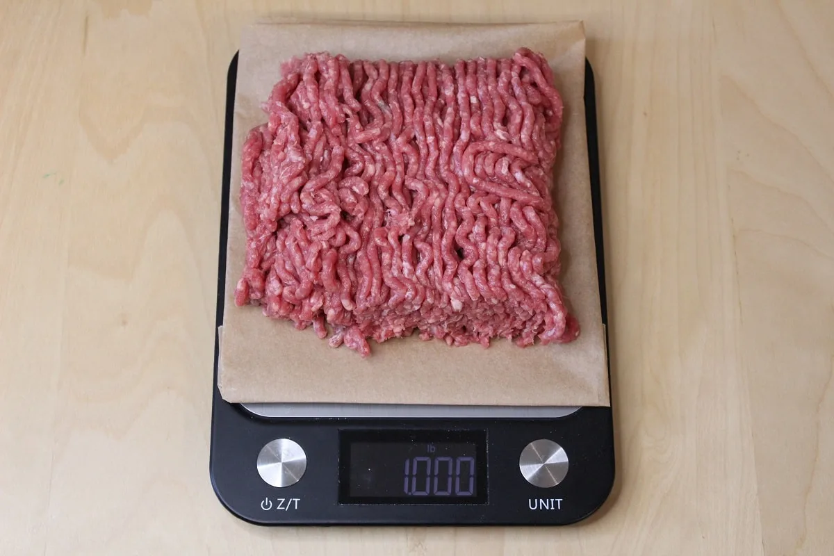 one pound of ground beef being weighed on a digital scale