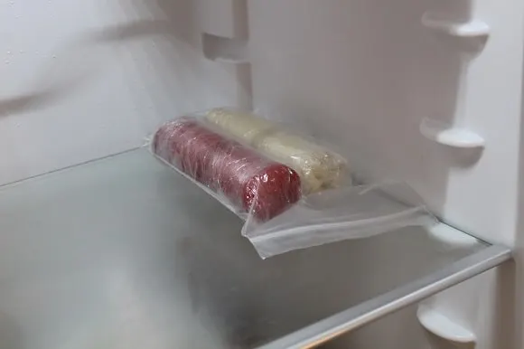 two rolls of sealed marzipan stored in the fridge