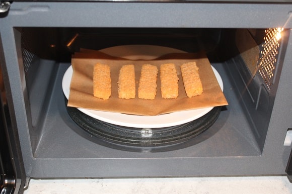 thawed fish sticks ready to be microwaved