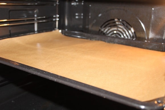 a baking sheet lined with brown parchment paper
