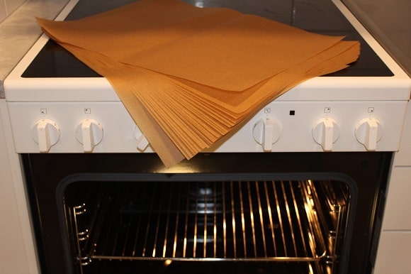 a stack of brown parchment paper on top of an oven