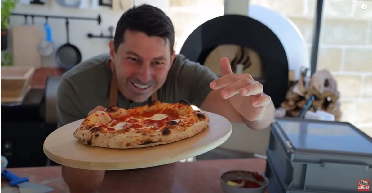 pizza chef and youtuber vito iacopelli with a freshly baked pizza