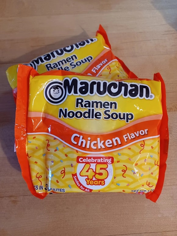 two packs of dry instant ramen noodles
