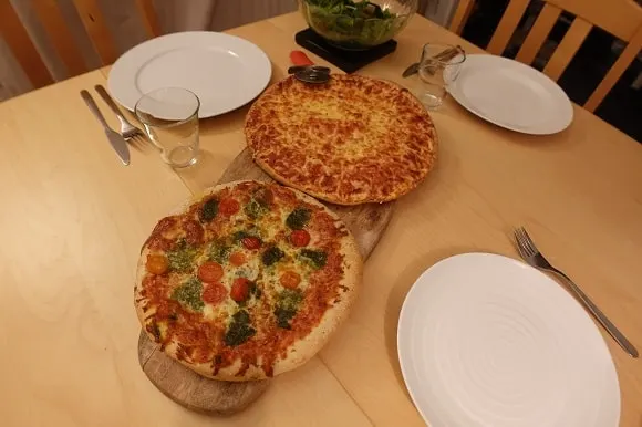 two cooked frozen pizzas on the dinner table
