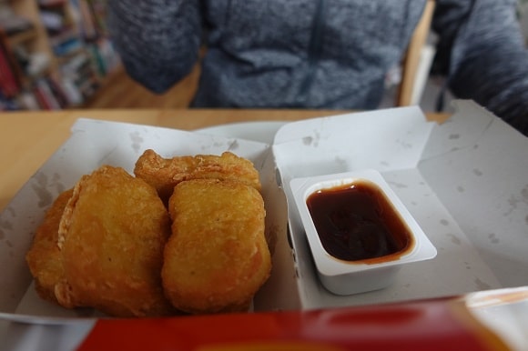one day old mcdonalds chicken nuggets in a box with dipping sauce