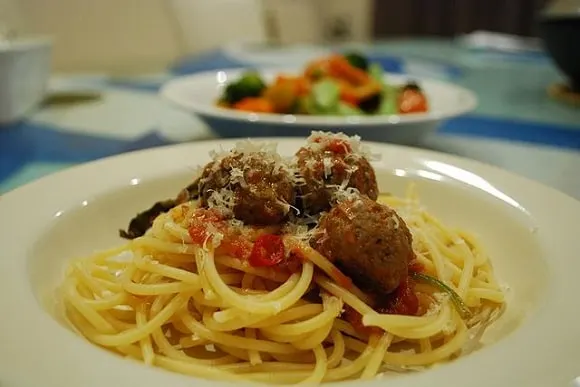 a plate of spaghetti and meatballs in tomato sauce