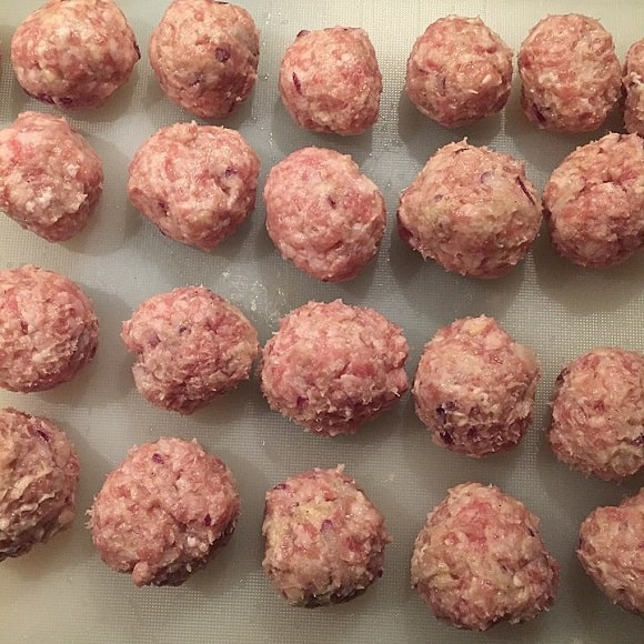 a bunch of freshly rolled homemade meatballs