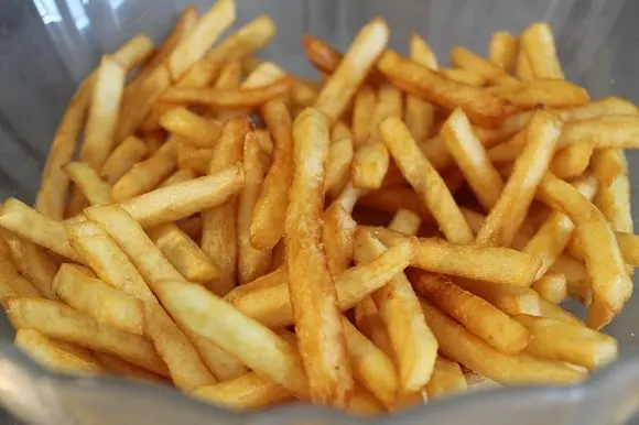 a portion of freshly fried french fries with salt